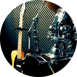 Electric guitar and drum set in studio.